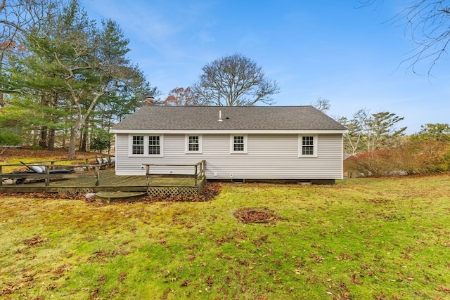 back of house featuring a wooden deck and a lawn