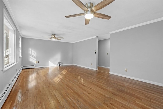 empty room featuring crown molding, baseboards, and wood-type flooring