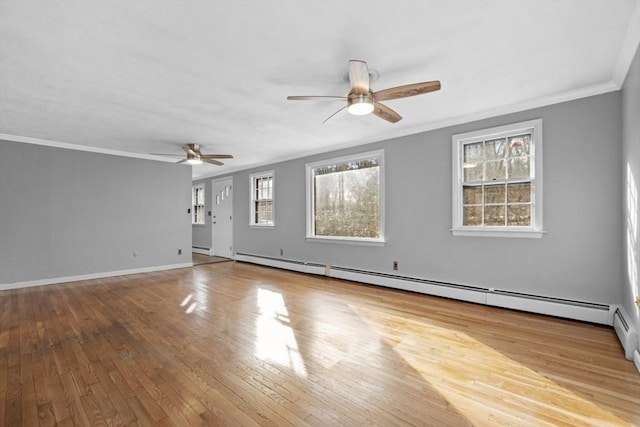 empty room featuring crown molding, baseboards, hardwood / wood-style floors, a ceiling fan, and a baseboard radiator