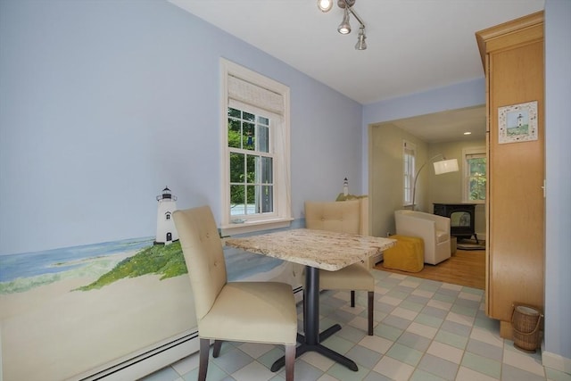1230 Rte 149, Barnstable, MA 02648 - dining room featuring baseboard heating and a wood stove