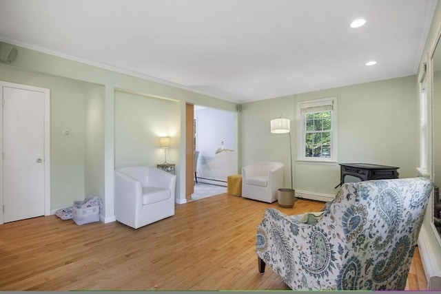 1230 Rte 149, Barnstable, MA 02648 - living area featuring a baseboard radiator, light wood-type flooring, recessed lighting, ornamental molding, and baseboard heating