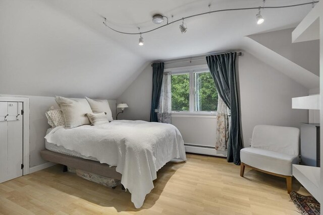 1230 Rte 149, Barnstable, MA 02648 - bedroom featuring lofted ceiling, a baseboard heating unit, and light wood-style flooring