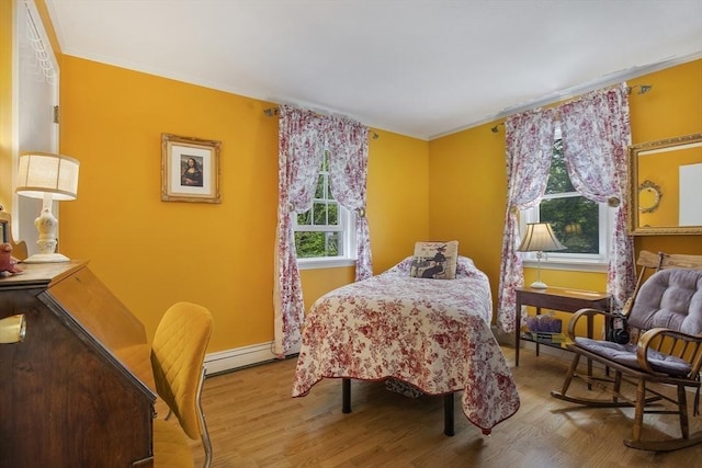 1230 Rte 149, Barnstable, MA 02648 - bedroom with wood finished floors, baseboard heating, crown molding, and baseboards