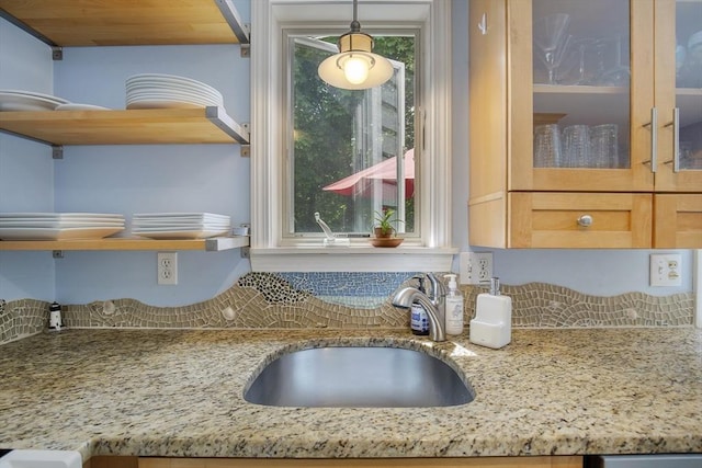 1230 Rte 149, Barnstable, MA 02648 - kitchen view of a sink, light stone counters, tasteful backsplash, open shelves, and pendant lighting
