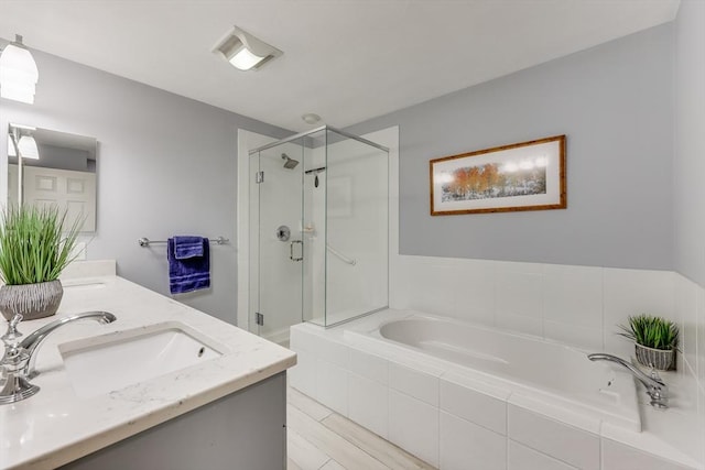 bathroom featuring vanity and separate shower and tub