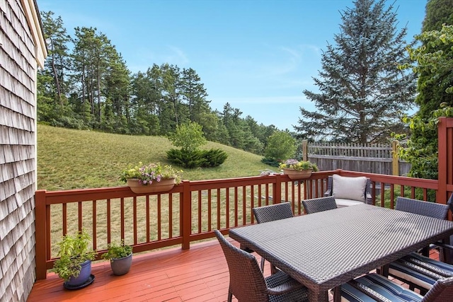 wooden deck with a lawn