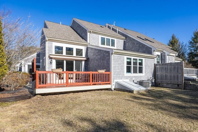 rear view of house with a deck, a lawn, and central air condition unit