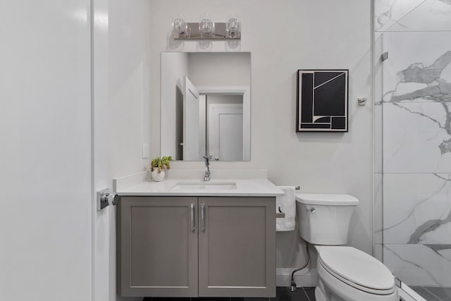 bathroom with a shower, vanity, and toilet