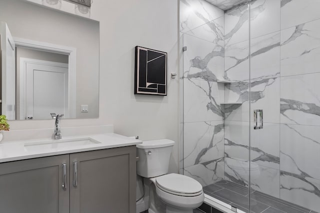 bathroom featuring walk in shower, vanity, and toilet