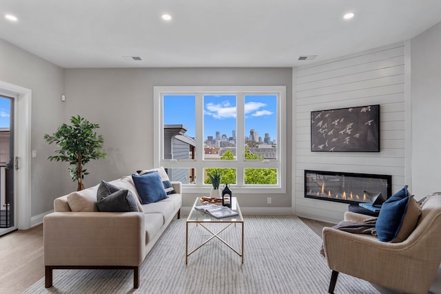 living room with a fireplace and light hardwood / wood-style floors