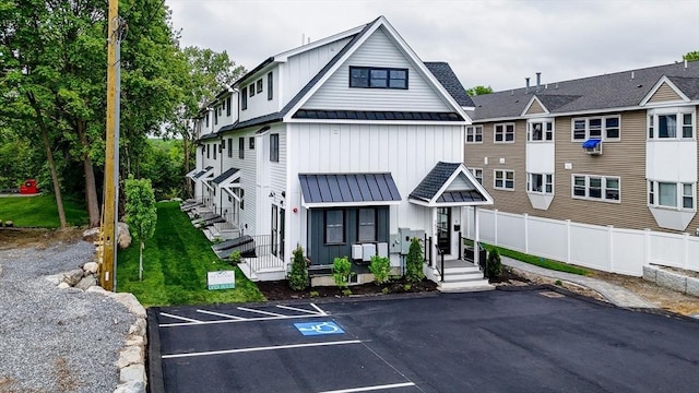 1514 Gorham St Unit 4, Lowell, MA 01852 - view of front facade with a standing seam roof, metal roof, board and batten siding, and uncovered parking