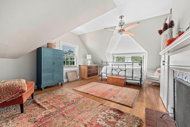 bedroom featuring ceiling fan, dark hardwood / wood-style flooring, and lofted ceiling