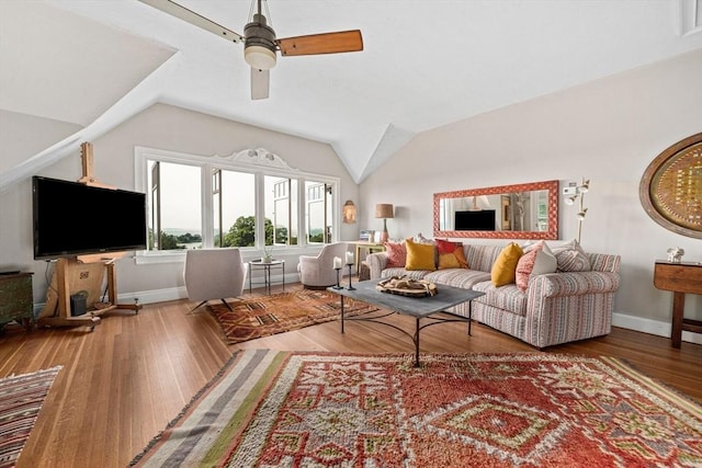 living room featuring hardwood / wood-style flooring, ceiling fan, and vaulted ceiling