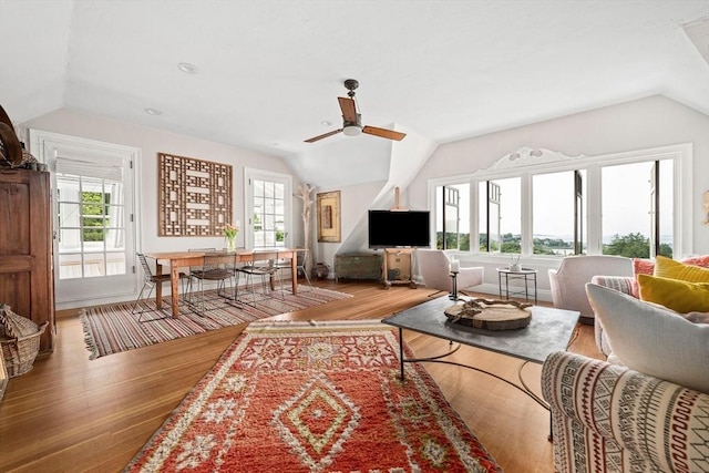 living room with vaulted ceiling, ceiling fan, and wood-type flooring