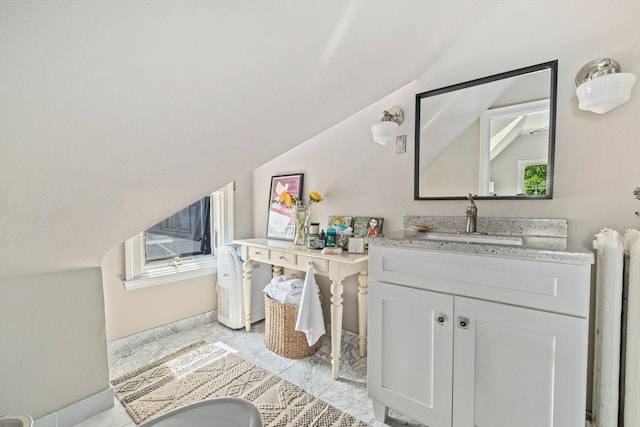 bathroom with vanity and vaulted ceiling