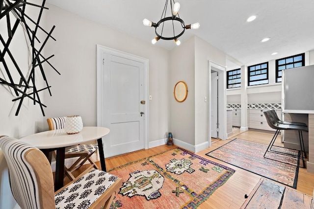 entrance foyer featuring light hardwood / wood-style flooring and an inviting chandelier