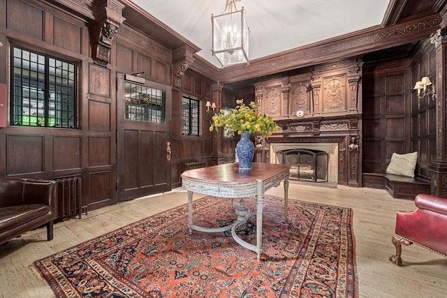 interior space with wood walls, light hardwood / wood-style flooring, and ornamental molding