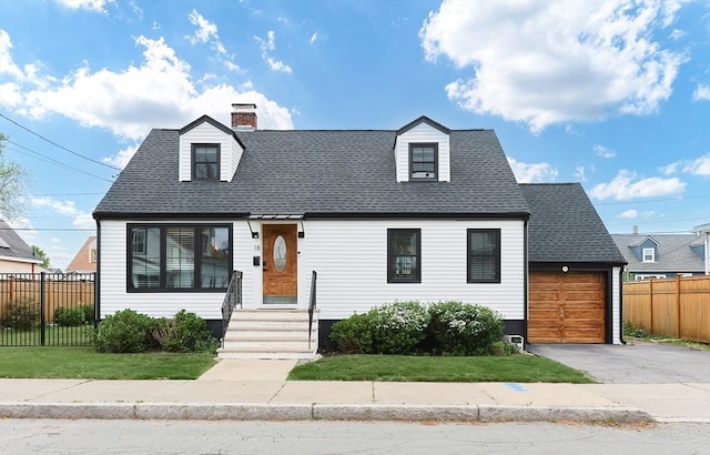 18 Carolina St, Medford, MA 02155 - new england style home with asphalt driveway, a garage, roof with shingles, and a chimney