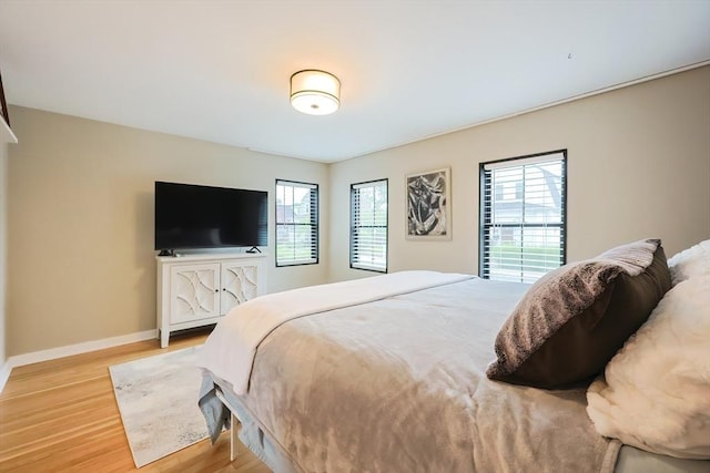18 Carolina St, Medford, MA 02155 - bedroom featuring multiple windows, light wood-style flooring, and baseboards