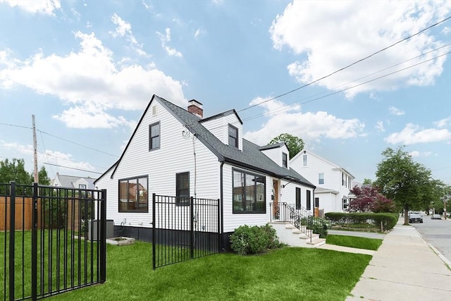 18 Carolina St, Medford, MA 02155 - view of side of home featuring a chimney, a shingled roof, and central AC