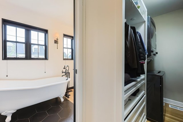 18 Carolina St, Medford, MA 02155 - full bathroom featuring a freestanding tub, tile patterned floors, and baseboards
