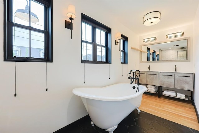 18 Carolina St, Medford, MA 02155 - bathroom featuring a freestanding bath, double vanity, and tile patterned floors