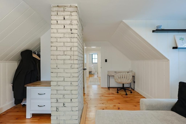 18 Carolina St, Medford, MA 02155 - additional living space with light wood finished floors, lofted ceiling, and a decorative wall