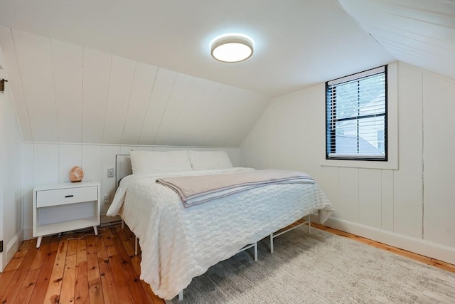 18 Carolina St, Medford, MA 02155 - bedroom with light wood finished floors, lofted ceiling, a decorative wall, and baseboards