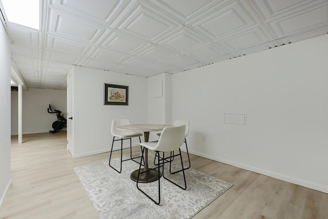 18 Carolina St, Medford, MA 02155 - dining space with light wood-style flooring, baseboards, and an ornate ceiling