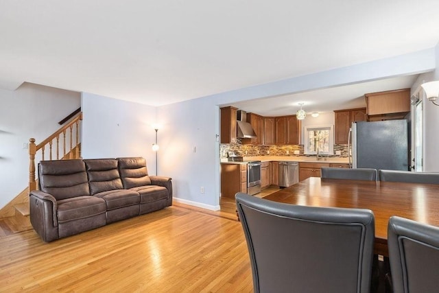 living room featuring sink and light hardwood / wood-style floors