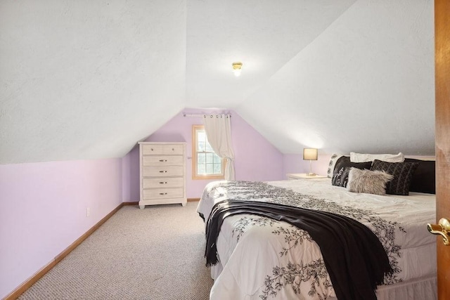 carpeted bedroom featuring vaulted ceiling