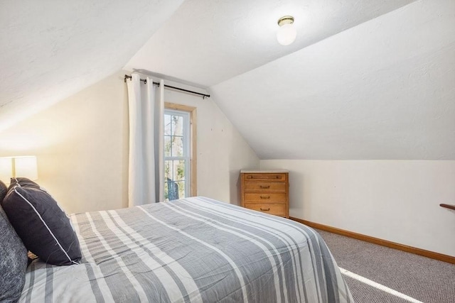 carpeted bedroom with lofted ceiling