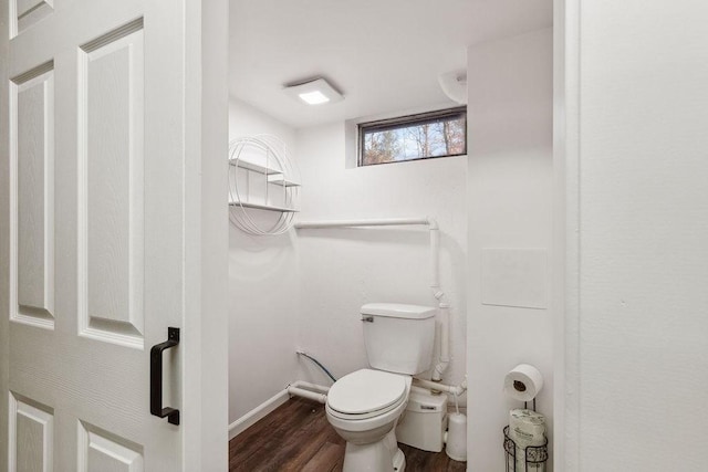 bathroom featuring hardwood / wood-style flooring and toilet