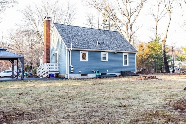 back of house featuring a gazebo and a yard