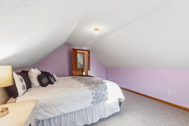 bedroom featuring carpet and lofted ceiling