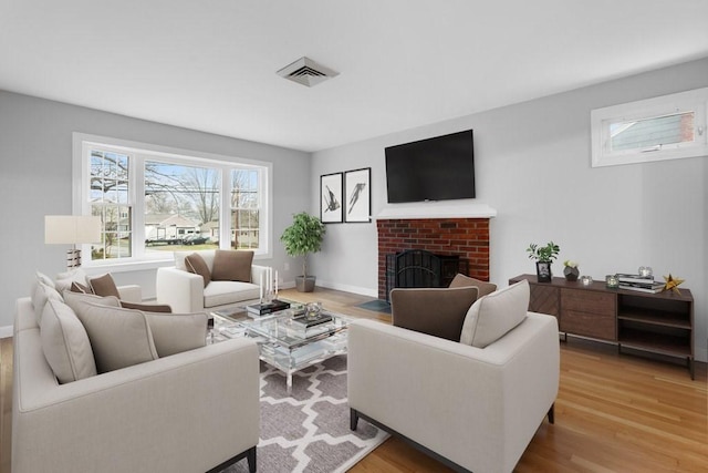 living room featuring a fireplace and wood-type flooring