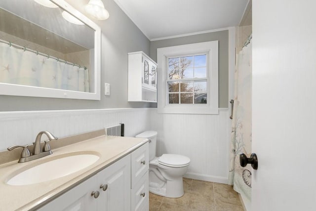 bathroom with tile patterned flooring, vanity, toilet, and ornamental molding