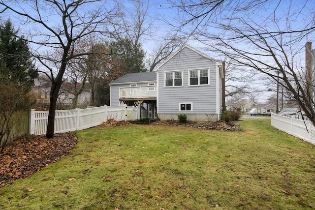 rear view of house featuring a lawn