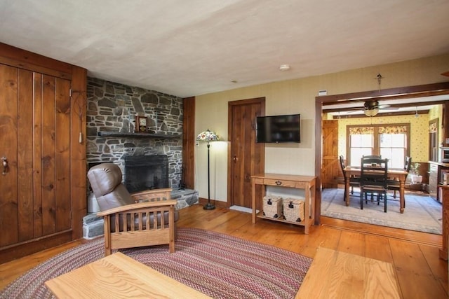 310 S River Rd, Charlemont, MA 01339 - living area with ceiling fan, a stone fireplace, and wood-type flooring