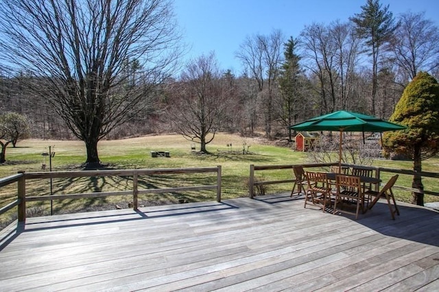 310 S River Rd, Charlemont, MA 01339 - wooden deck featuring a lawn, outdoor dining space, and an outbuilding