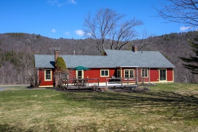 310 S River Rd, Charlemont, MA 01339 - back of property featuring a yard, a shingled roof, a deck with mountain view, and a chimney