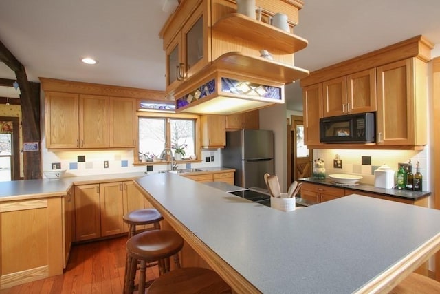 310 S River Rd, Charlemont, MA 01339 - kitchen with recessed lighting, a sink, a kitchen bar, black microwave, and freestanding refrigerator
