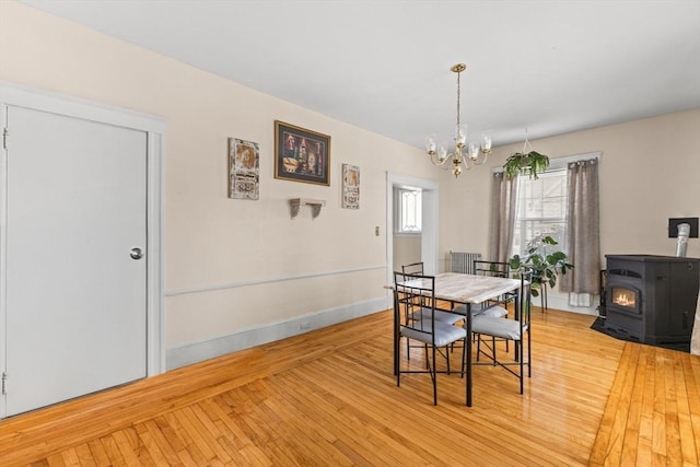 51 Gifford St, Brockton, MA 02301 - dining room featuring a chandelier, a wood stove, wood-type flooring, and baseboards