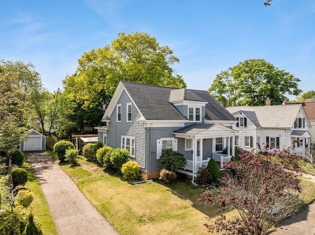 51 Gifford St, Brockton, MA 02301 - shingle-style home featuring covered porch, asphalt driveway, an outbuilding, a detached garage, and a front yard