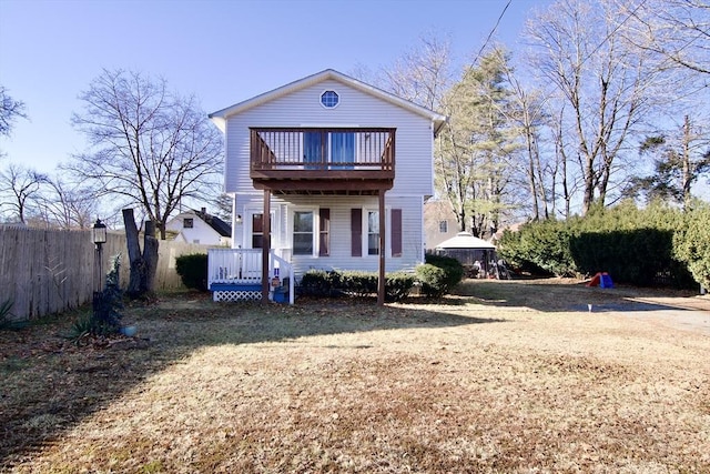 back of house featuring a yard and a deck