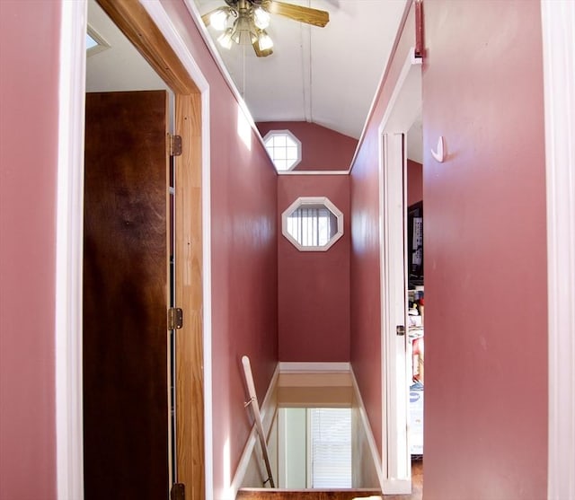 doorway to outside with ceiling fan and lofted ceiling