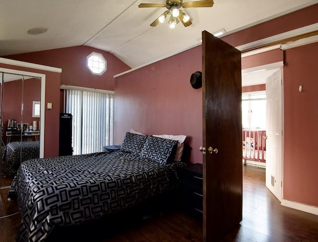 bedroom with a closet, dark wood-type flooring, ceiling fan, and lofted ceiling