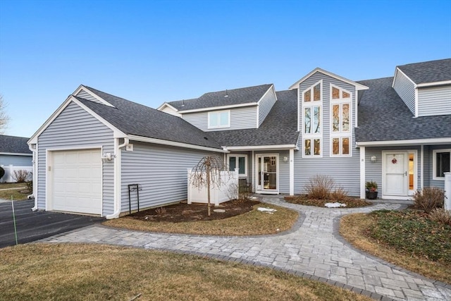 front of property with a garage and a front lawn