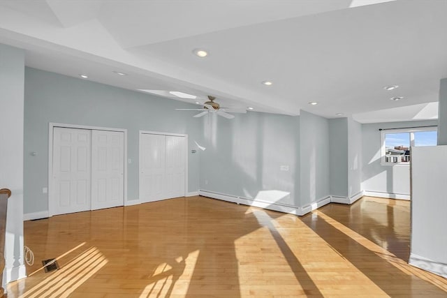 interior space with hardwood / wood-style floors, ceiling fan, and a baseboard radiator