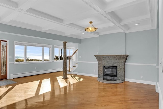 unfurnished living room featuring light hardwood / wood-style flooring, baseboard heating, and coffered ceiling